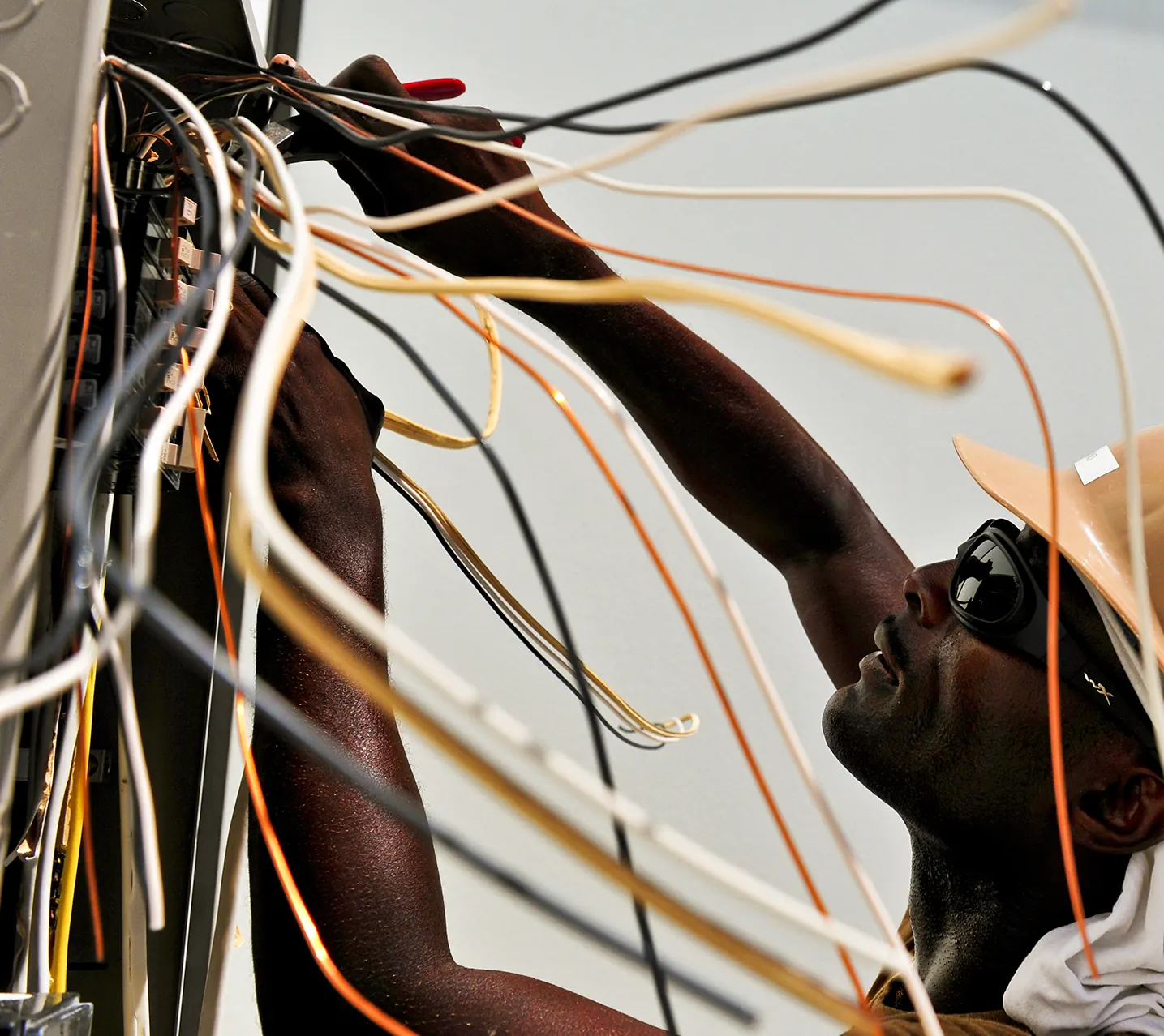 Electrician maintaining wiring and cable connections